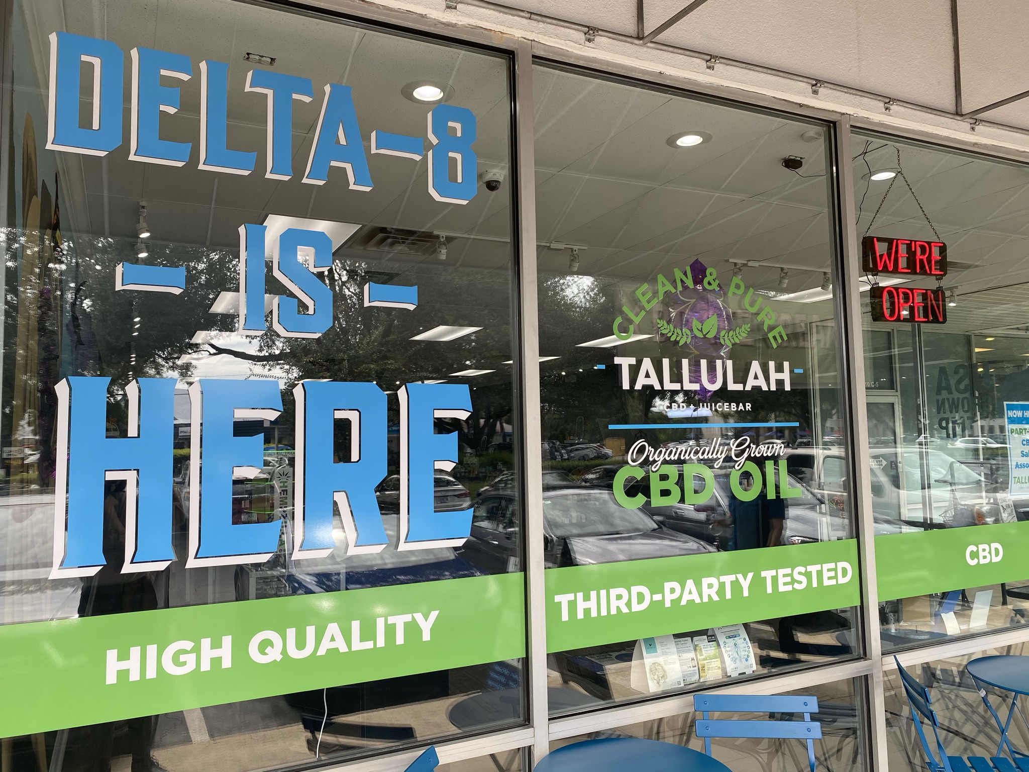 Storefront sign that says Delta-8 Is Here